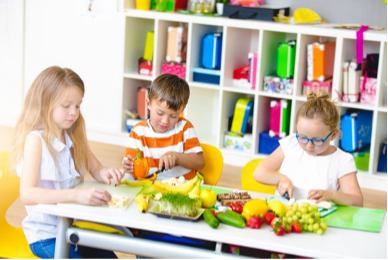 Kids cutting food at school.png